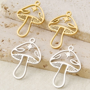 Macro view of gold and silver hollow mushroom pendants for DIY jewelry making