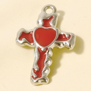 Detailed macro view of 304 stainless steel cross pendant with red enamel heart accent