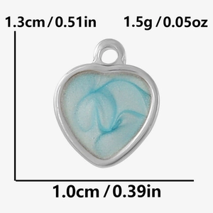 Detailed view of heart charm with blue marble enamel finish and dimension markings