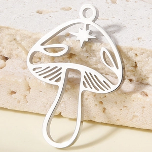Macro shot of 304 stainless steel mushroom pendant with star patterns for DIY jewelry