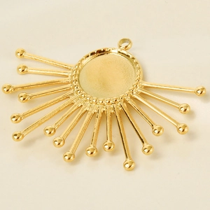 Detailed macro view of a golden stainless steel sunflower pendant base for DIY jewelry