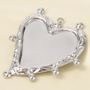 Close-up of heart-shaped stainless steel pendant base with beaded edges for DIY jewelry