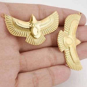 Detailed close-up of 18k gold 304 stainless steel flying bird pendant with wing texture