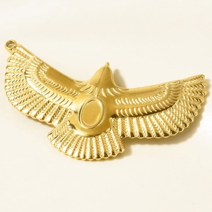 Detail of 18k gold plated flying bird pendant with intricate feather textures