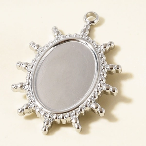 Detailed view of silver sunburst pendant base with bead edge for DIY jewelry making