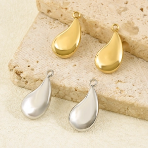 Polished 304 stainless steel water drop pendants in gold and silver on stone