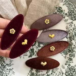 Retro velvet oval hair clips with golden heart and rhinestone flower accents in multiple colors