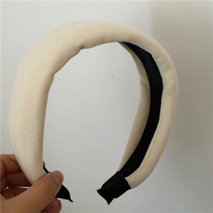 Détail d'un serre-tête en éponge épaisse crème avec doublure antidérapante noire et tissu doux