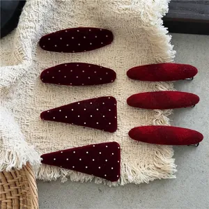 Red velvet polka dot and ribbed fabric hair clips set in oval and triangle shapes