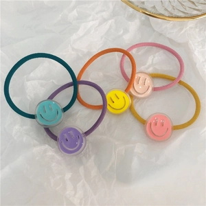 Close-up of colorful elastic hair ties set with cute translucent smiley face pendants