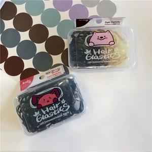 Detail of colorful hair elastics for kids in a box with cute cartoon illustrations