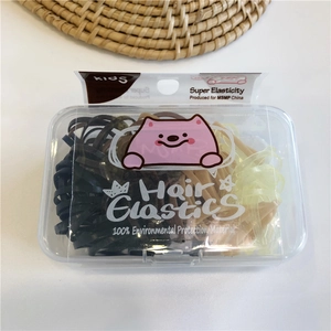 Detail view of colorful high elasticity hair ties in a clear storage box for kids