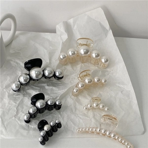 Elegant pearl hair claw clip set with white faux pearls on black and clear resin bases