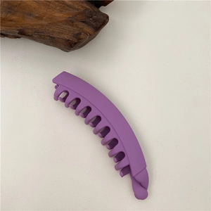 Macro detail of matte purple banana hair clip showing secure inner teeth grip design