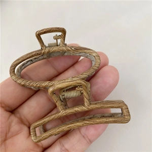 Detail view of oval and rectangular hair claws with a retro wood grain texture