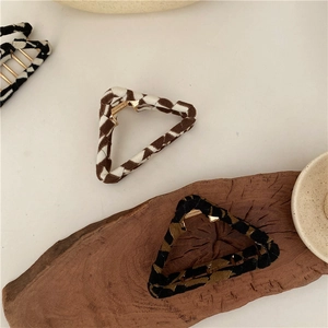Detail of vintage checkered hair claws with elegant fabric texture and metal spring