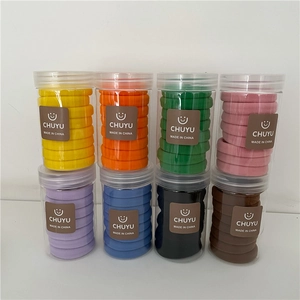 Detail view of 8-pack candy color seamless hair ties in transparent cylinder jars