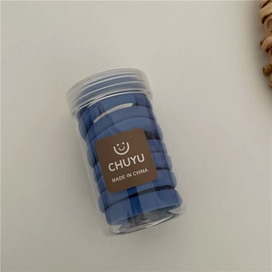 Close-up of blue high-elasticity seamless hair ties stored in a clear cylinder jar