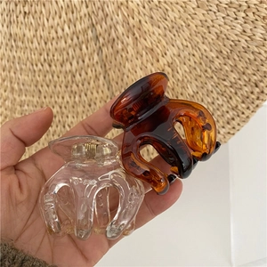 Medium minimalist shark hair clips in amber and transparent resin for elegant styling