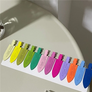 Set of twelve colorful matte duckbill hair clips neatly arranged on a white display card