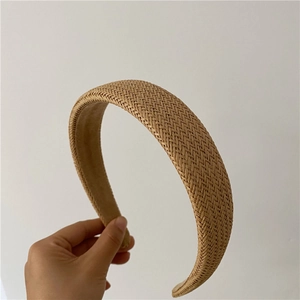 Detail of light brown hand-woven headband with herringbone texture and soft velvet lining