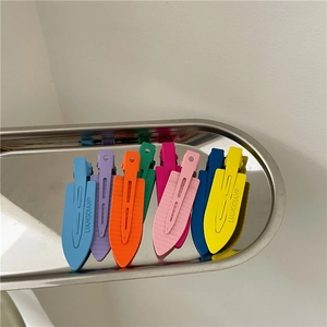 Set of 8 matte macaron hair clips in vibrant summer colors arranged on a metal tray