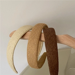 Three-piece set of woven headbands in cream, light brown, and dark brown colors