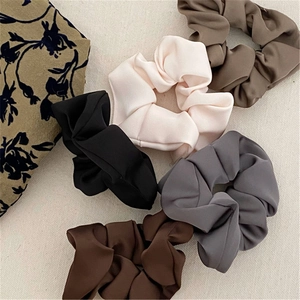 Elegant satin scrunchie set in assorted earth tones including black, mocha and pink