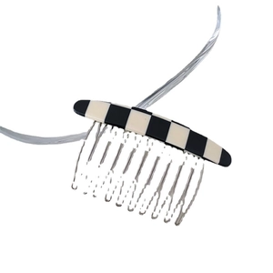 Minimalist checkerboard pattern hair comb with silver teeth and black white marble texture