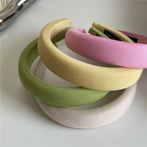 Thick sponge headbands in pastel colors featuring a handmade woven label for girls