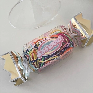 Detail of candy-shaped box with colorful elastic hair ties for girls and children