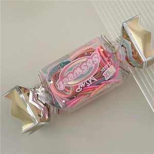 Detail view of colorful high-elasticity hair ties in creative candy-shaped packaging