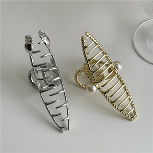 Elegant silver and gold metal hair claws with pearl accents and twisted texture design