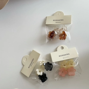 Close-up of floral mini hair claws in jelly colors and beige accessories card packaging