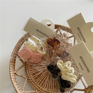 Detailed view of colorful jelly-colored mini bow hair clips in retail packaging