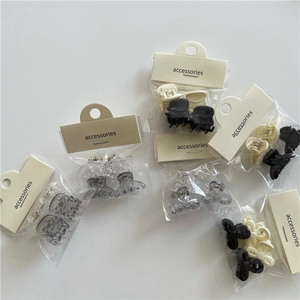Mini plastic jelly bow hair claws in various colors with retail hanging card packaging