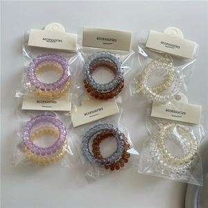Set de 12 gomas de pelo de espiral transparentes en varios colores con ganchos