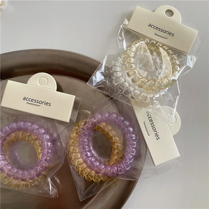 Set de dos gomas de pelo de cable telefónico transparentes en morado y amarillo