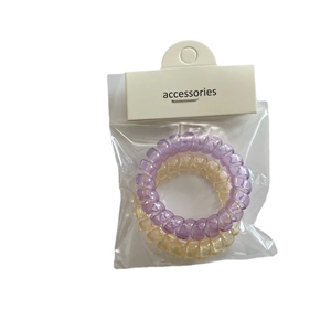 Set de dos gomas de pelo en espiral transparentes en colores violeta y naranja