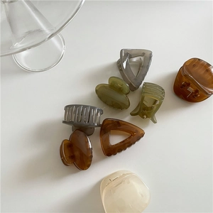 Transparent geometric hair claws set in triangle and square shapes with amber resin finish