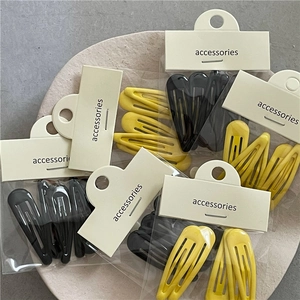 Lot de barrettes BB jaune crème et noir pour femmes avec emballage minimaliste sur plateau