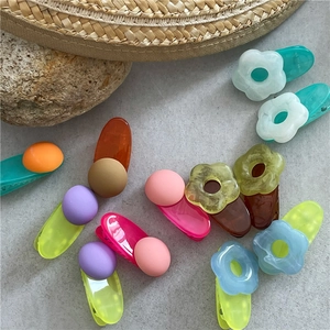 Colorful floral and round jelly hair clips set on a summer vacation background