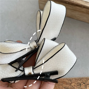 Elegant white satin bow hair clips with black edges and pearls for women