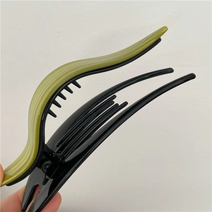 Detailed close-up of large olive green acetate and black claw clip with strong teeth