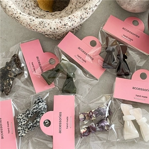 Cute acetate bow hair clips in various trendy patterns with elegant backcard packaging