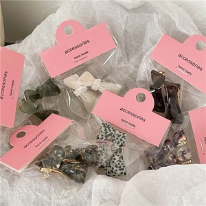 Mini acetate bow hair clips in leopard, marble, and amber patterns for women