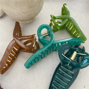 Jelly texture large hair claws in amber, green, and blue colors for thick hair styles