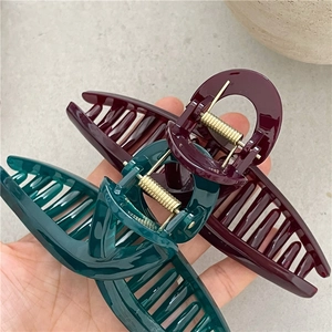 Large jelly texture hair claw clips in dark burgundy and forest green with gold springs