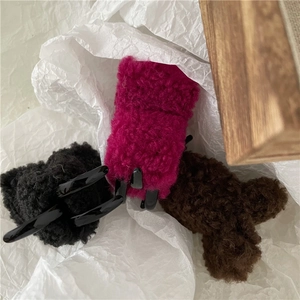 Detail of plush faux lamb wool hair claws in black, hot pink, and brown soft textures