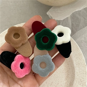 Set of 7 colorful flocked flower hair clips in various autumn colors with velvet texture